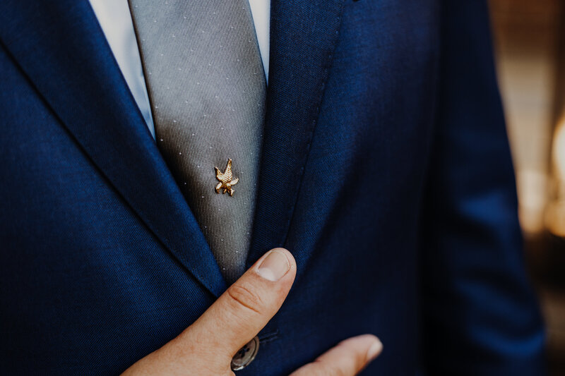 groom with blue suit and tie pin