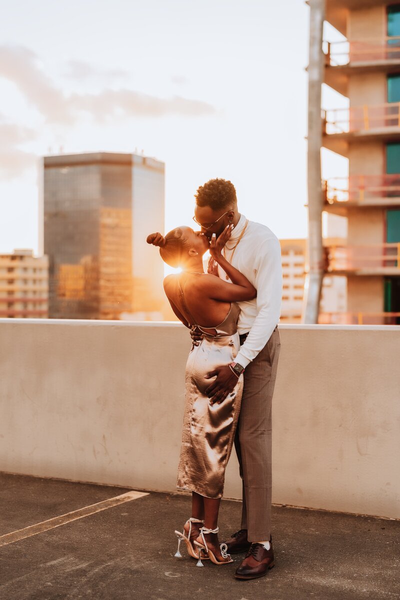 man and woman standing on parking deck kissing