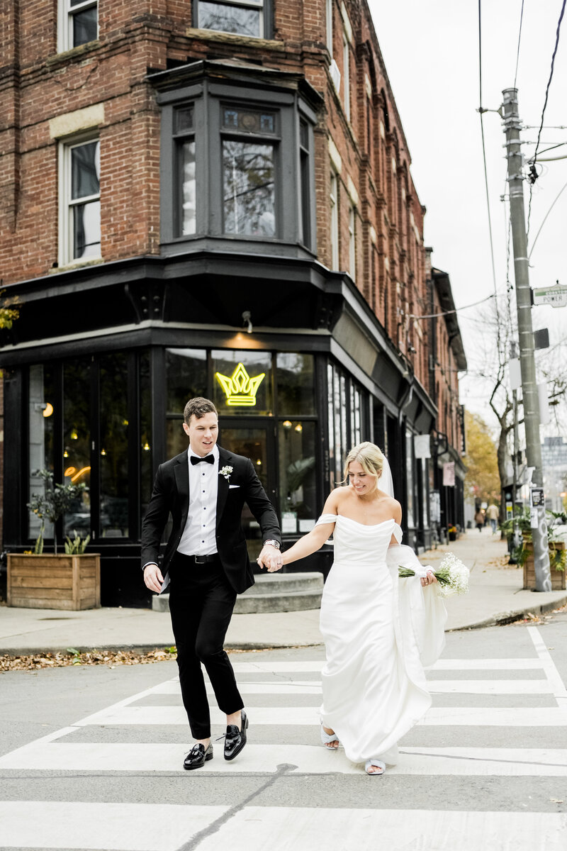 bride and groom cross Toronto street together