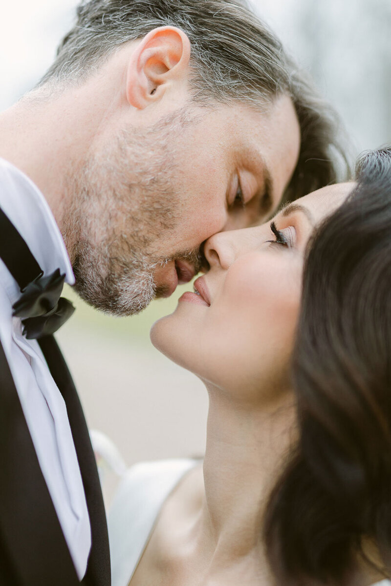 Bride and groom detail ceremony kiss