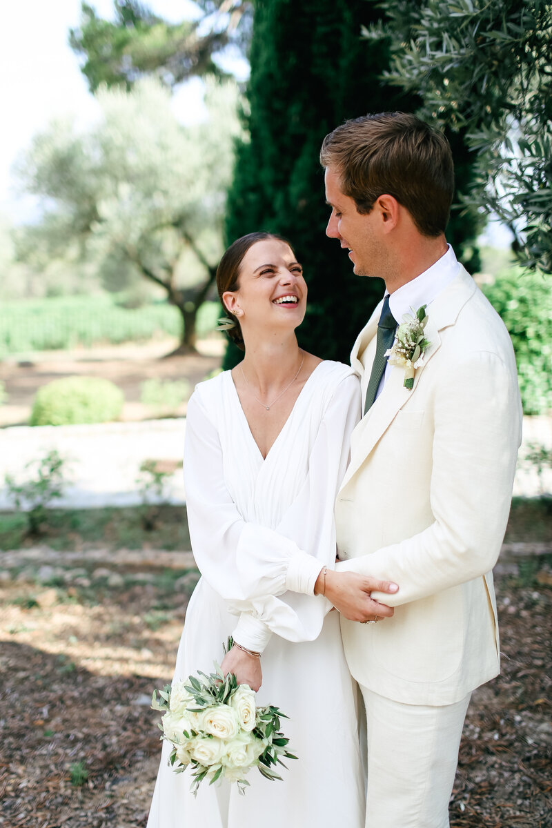 bride-and-groom-laughing-at-luxury-wedding-at-chateau-rasque