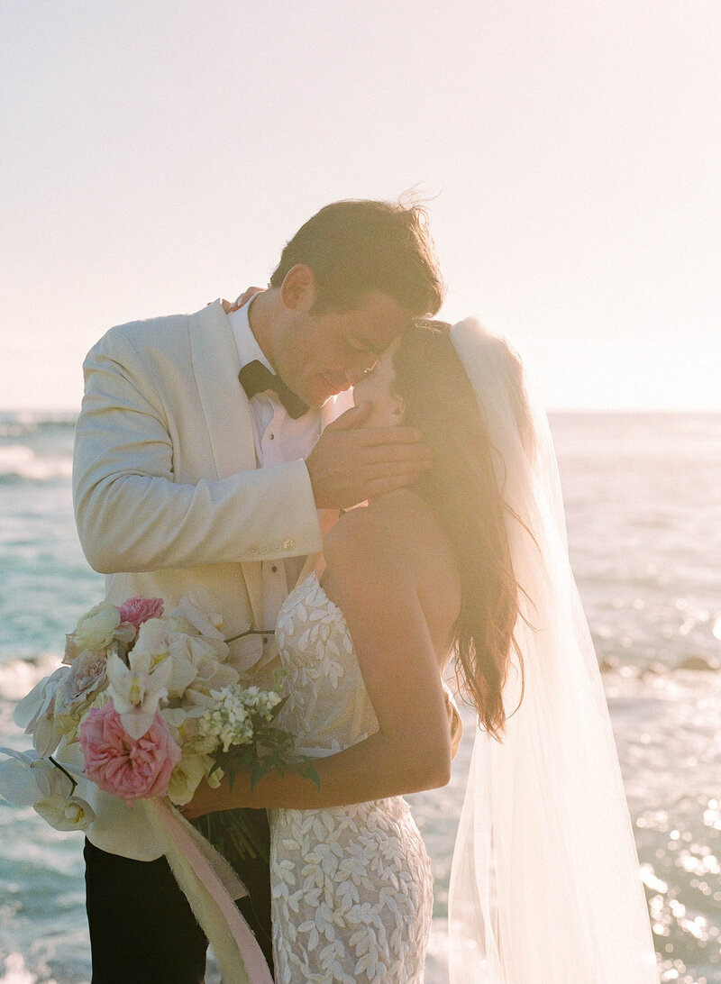 bride and groom married at sunset in hawaii at the beach house restaurant