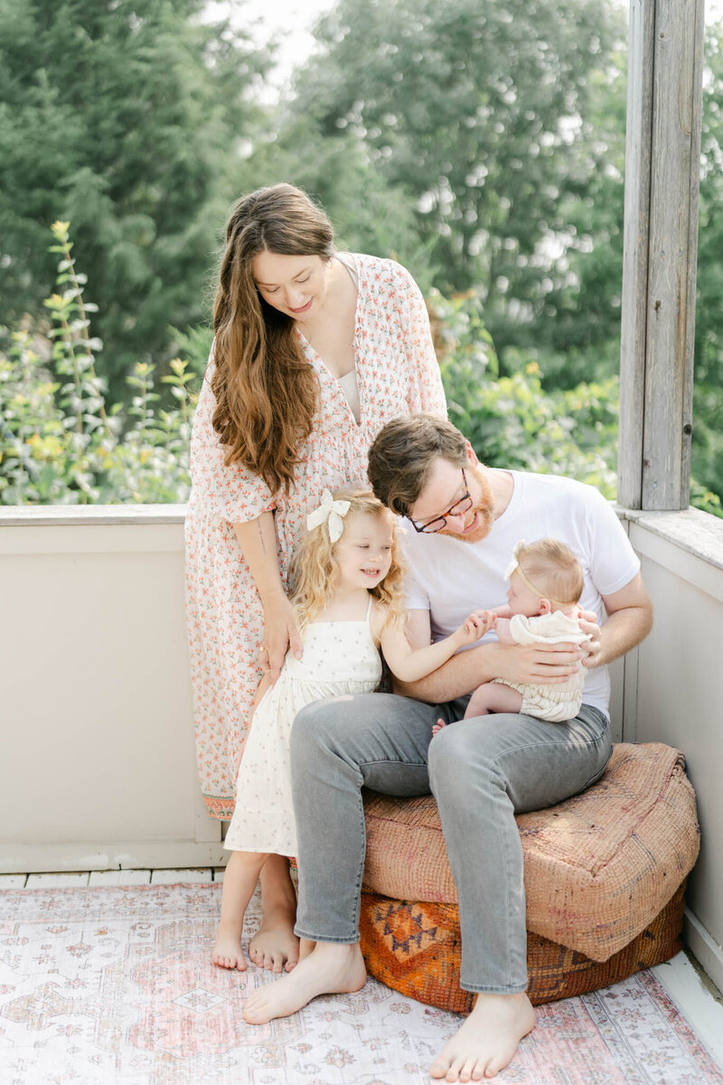 family poses with newborn baby and toddler