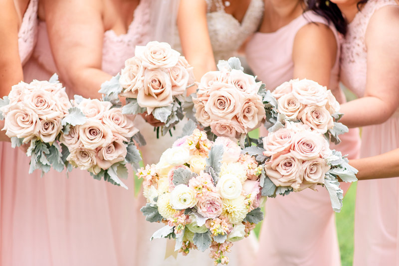 Peach, yellow, pink, and sage colored bouquets