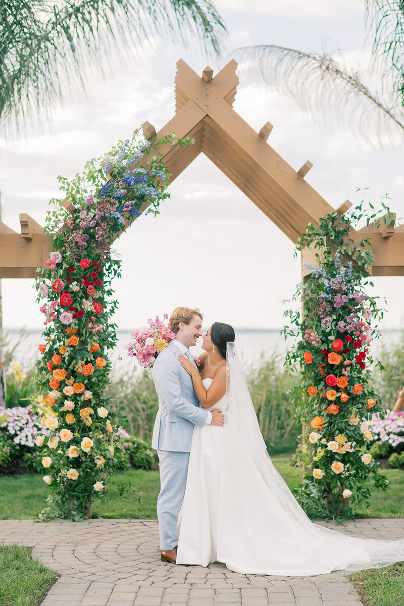 Bride and groom kissing on dock by Southern Maryland Wedding Photographer