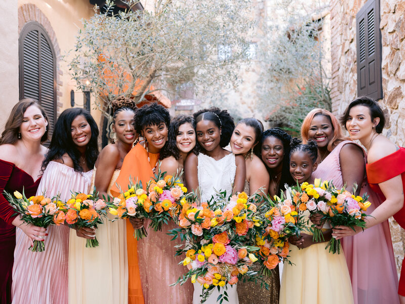 bride and bridesmaids pose with bouquets