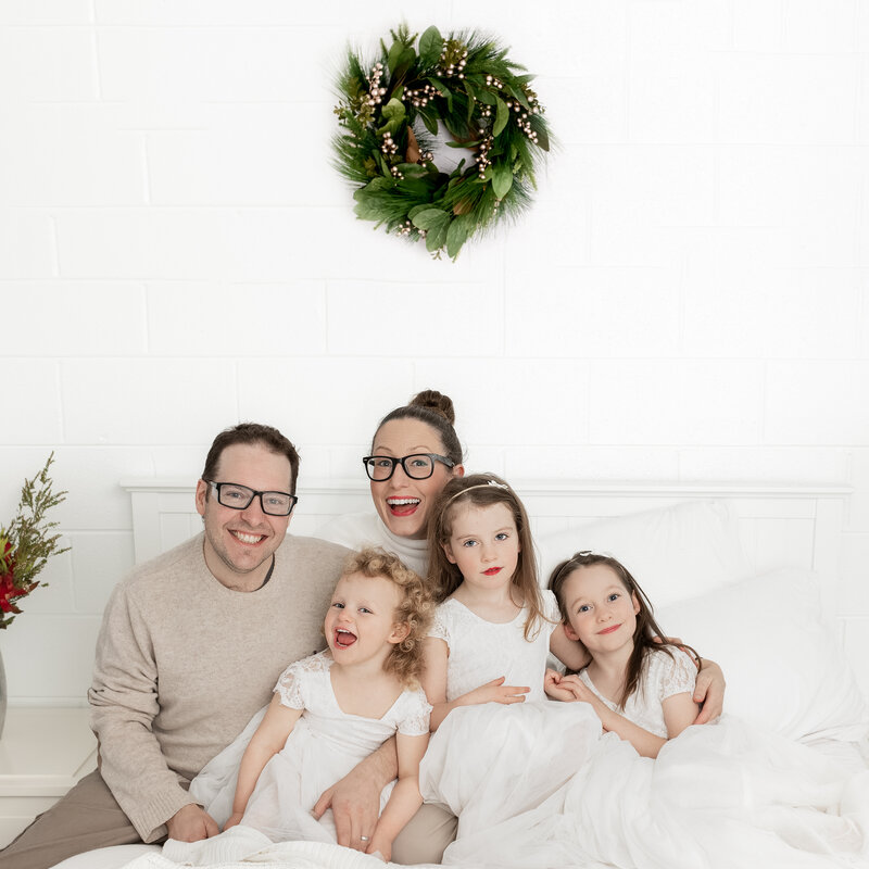 Family posing for a christmas photo by Lauren Vanier Photography