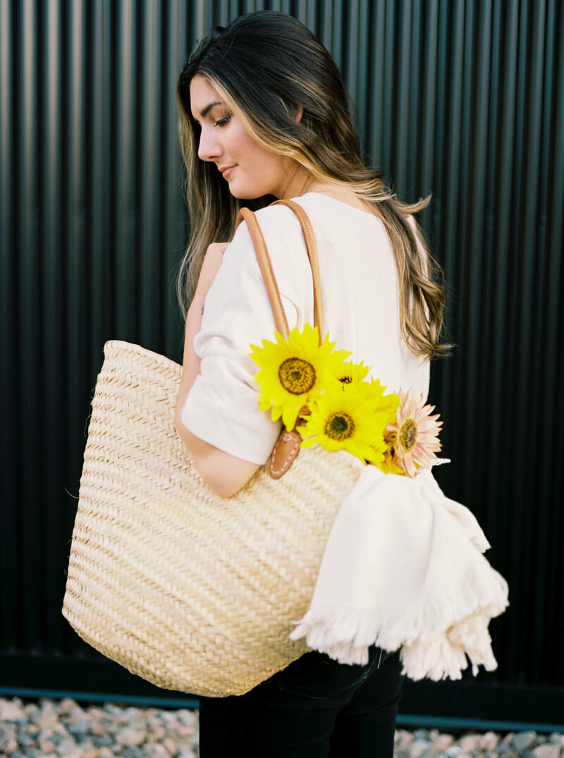 Alyssa Joy Halifax wedding photographer holding bag with sunflowers