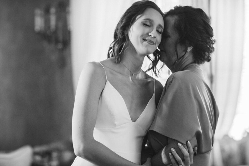 Mother of the bride whispers something in her daughter's ear
