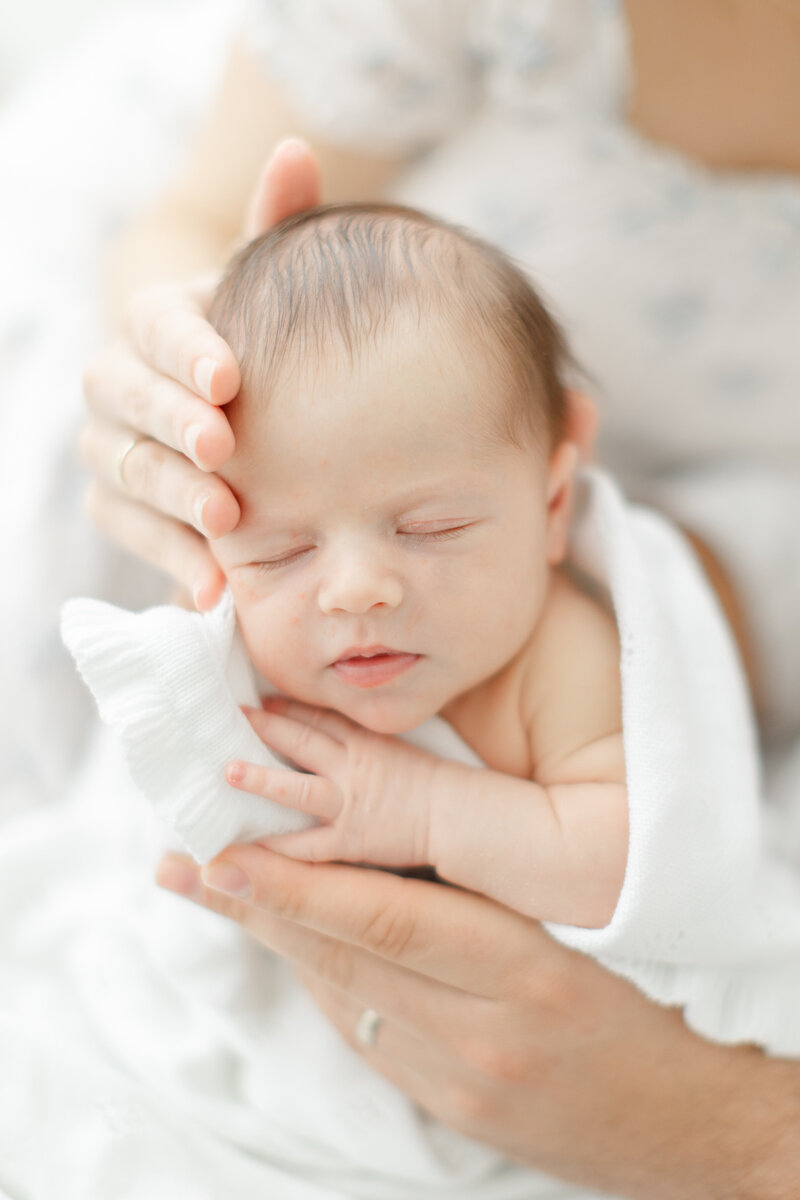 parent holding their newborn baby