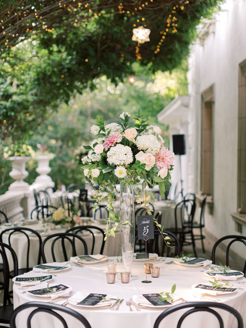 Elevated centerpiece with black chairs