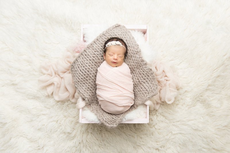 baby girl in light pink wrap