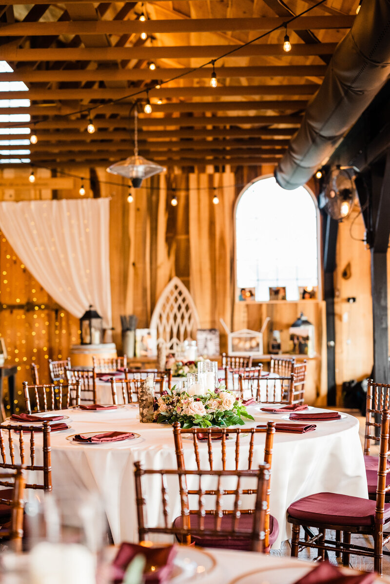 indoor northern virginia wedding venue decorated with warm tones, hanging lights and florals photographed by charlottesville wedding photographer