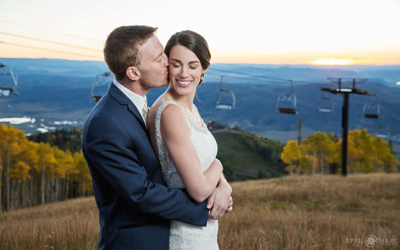 Bride and Groom with Ski Resort chairlift backdrop at Steamboat Ski Resort in Colorado during fall