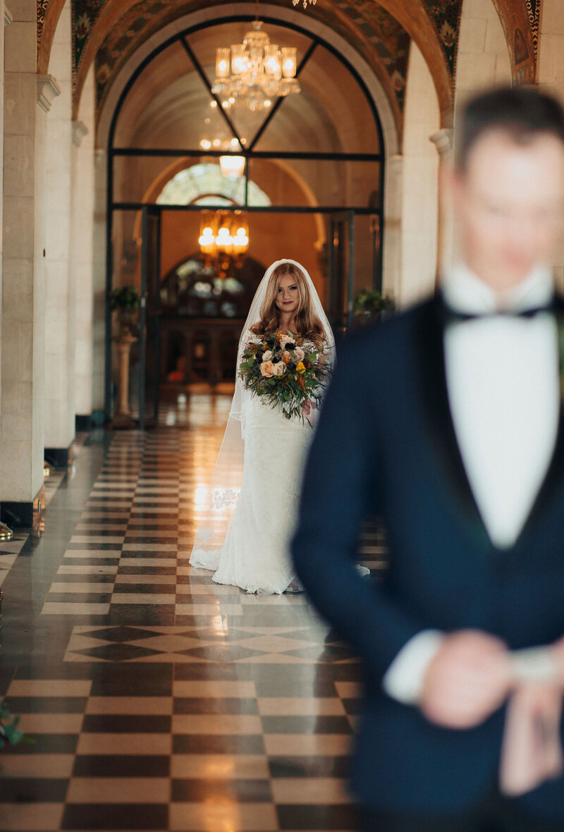 Bride walking down the aisle for first look reveal with Groom