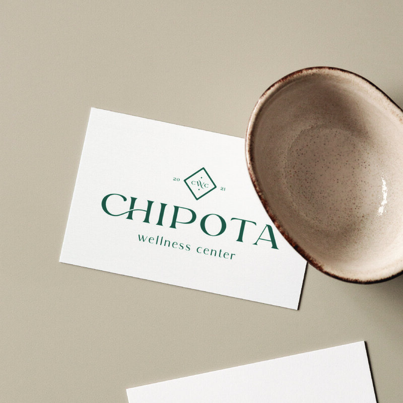 Branded business cards with logo for "Chipota Wellness Center" next to a ceramic bowl