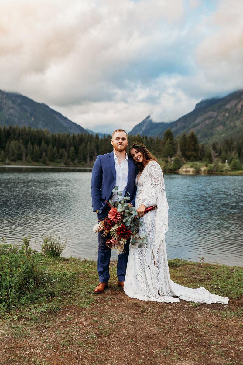couple standing at mountain lake