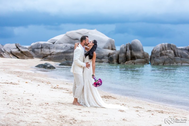 Bride and Groom kissing on beach Thailand