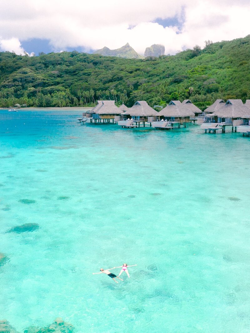 Luxury overwater bungalow in the Intercontinental Bora Bora, view on the couple and the lagoon