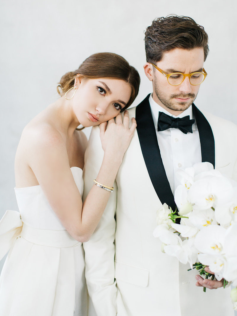 A destination wedding couple in wedding dress with removable cape and dinner jacket