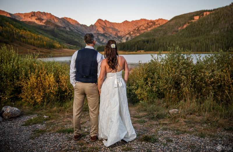 Bride and Groom look out at the lake at Piney River Ranch in Vail