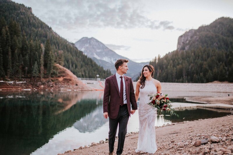 Sacramento Wedding Photographers capture couple holding hands walking alongside water
