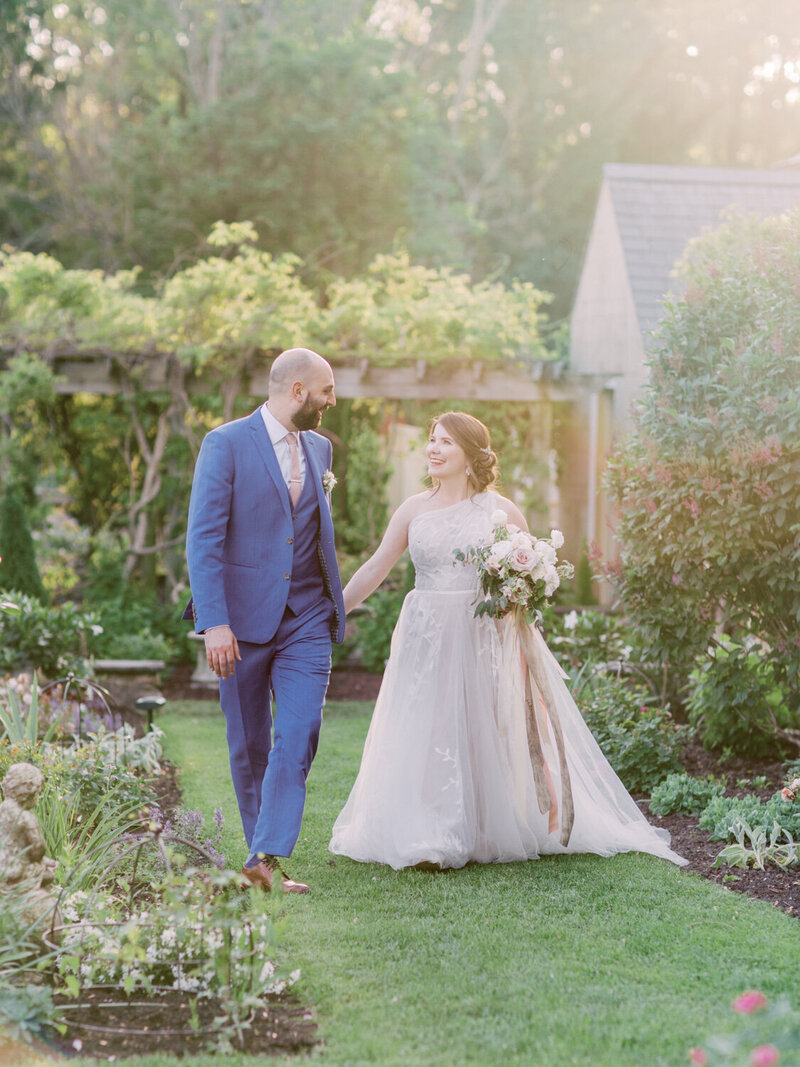 Bride and Groom  smiling at each other on a garden walk in the sunlight | Greencrest Manor | Jeannine Lillie Events | Anna Laero Photography | Pittsburgh Wedding Photographer