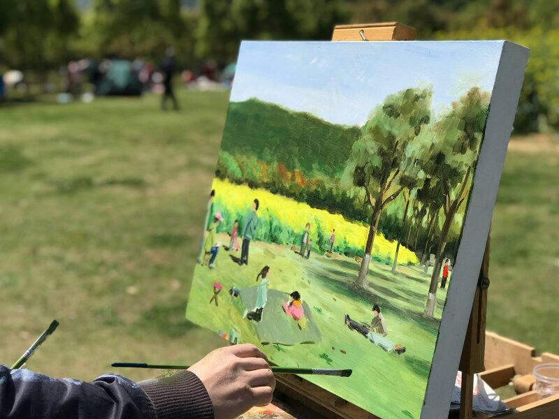 Retreat guest painting outdoors at Chateau Charente, capturing the French countryside during an intimate en plein air art session led by an expert artist.
