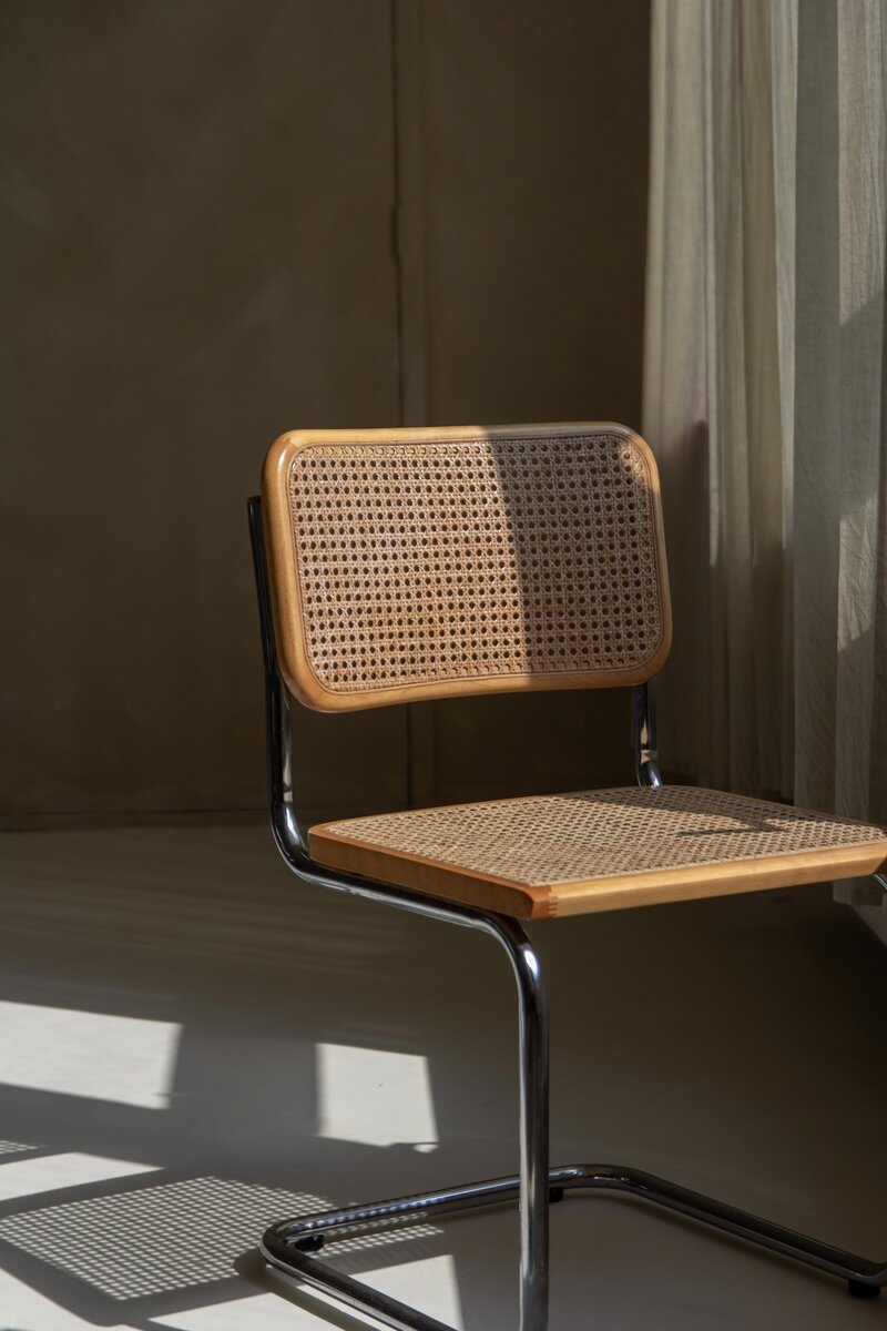 Chair with chrome frame and wood mesh seat and back sitting in a website design studio