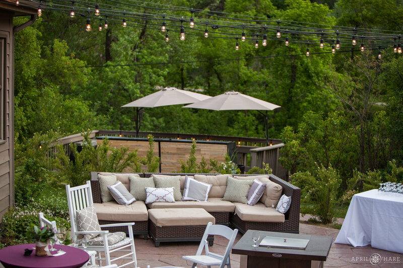 Cocktail Hour comfy patio seating with string lights and gas fireplace at Wedgewood Weddings in Colorado