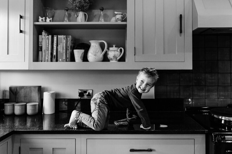black and white kid on kitchen counter photo