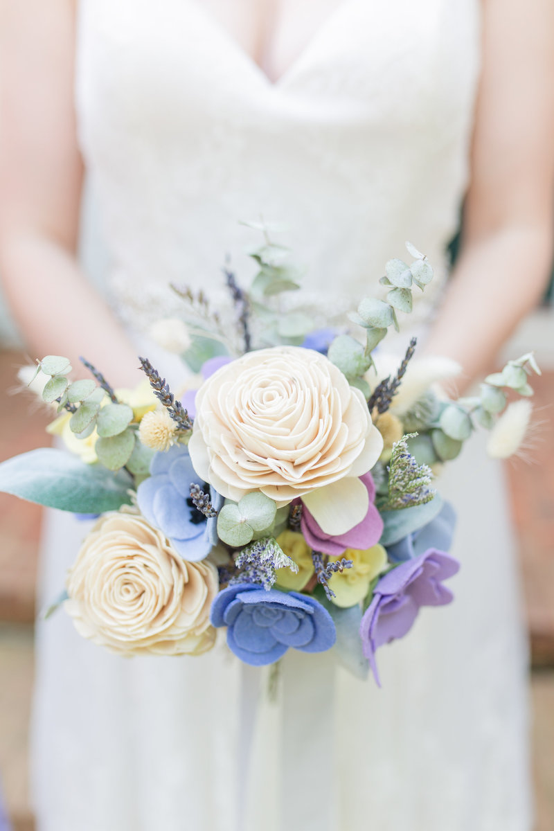 Photo of a bride holding a lavender bouquet at her Atlanta wedding by Jennifer Marie Studios.