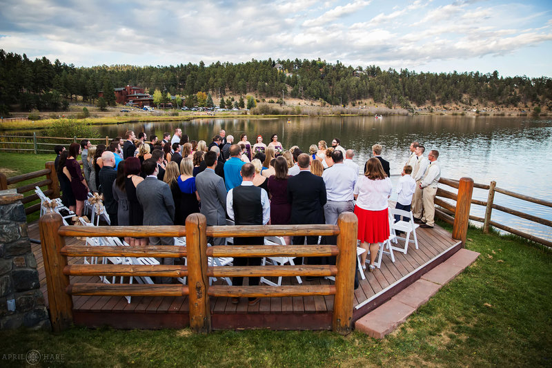 The octagon shaped back deck full of wedding guests for an outdoor ceremony at Evergreen Lake House
