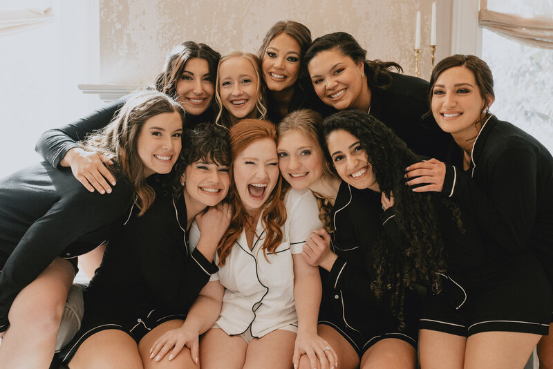 Bride and bridal party smiling