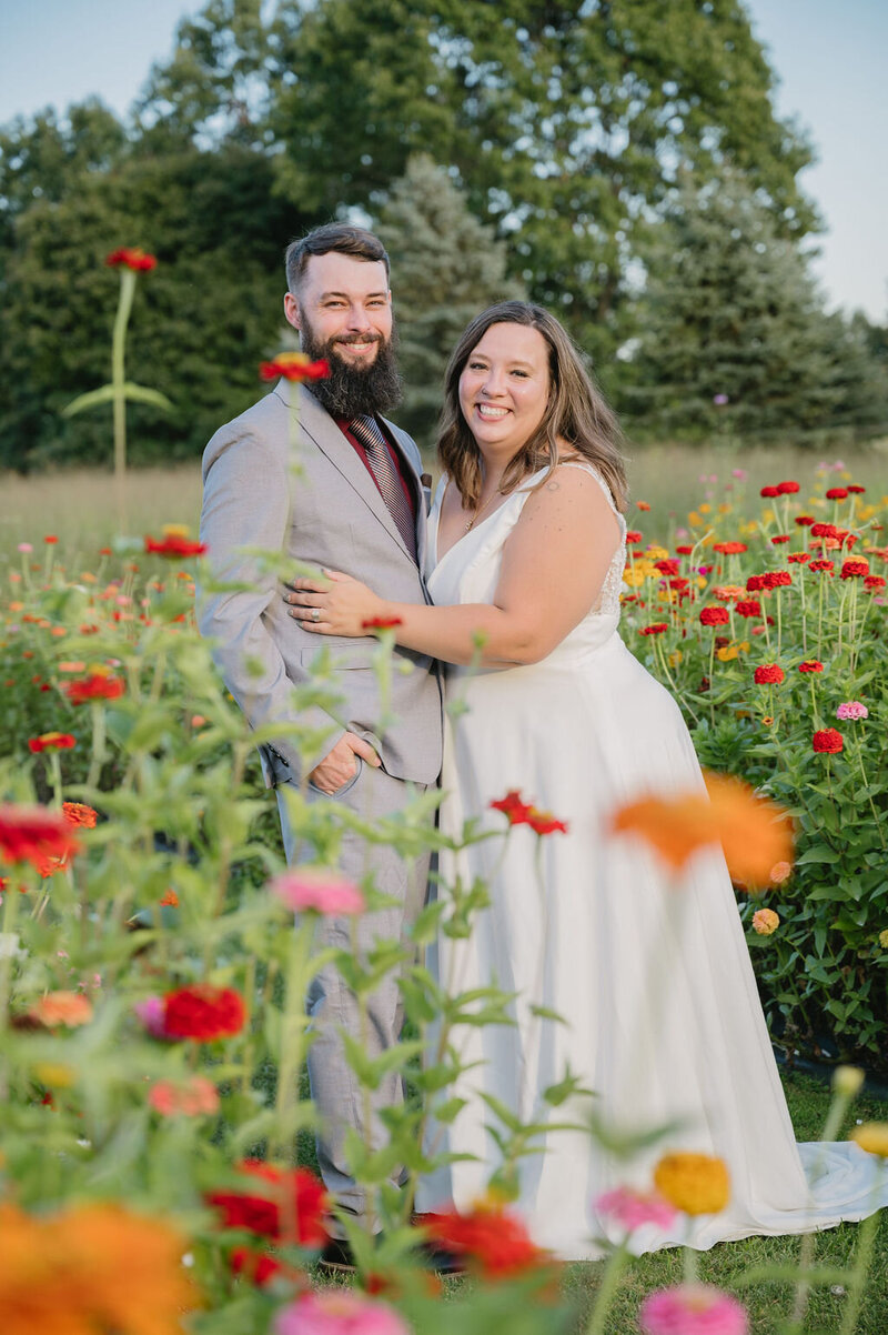 newly married couple kissing in flower field
