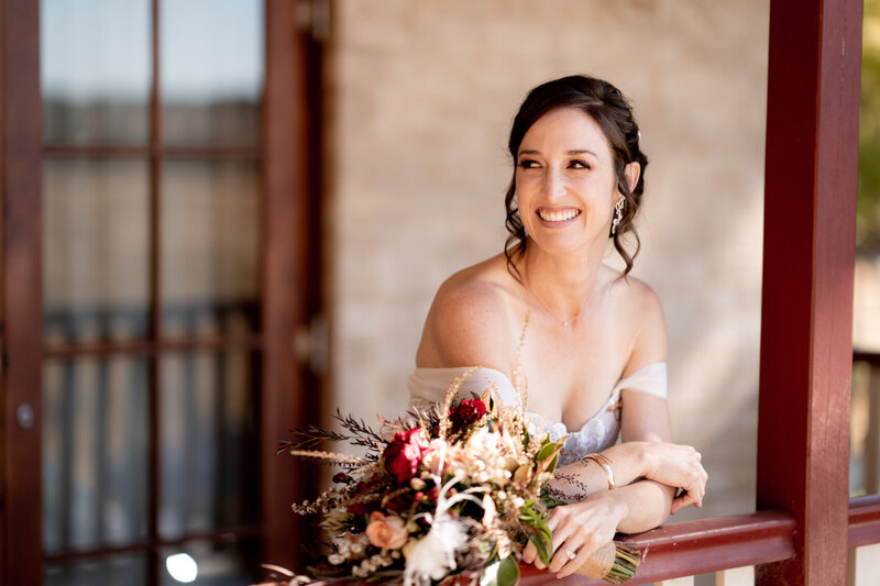 Bride smiling at the balcony
