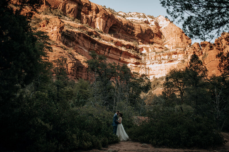 bride and groom dancing in sedona canyon