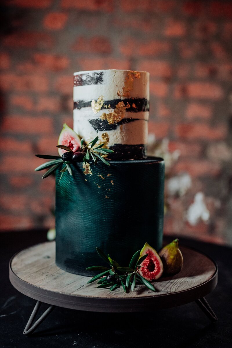 Dark emerald green rustic wedding cake with figs