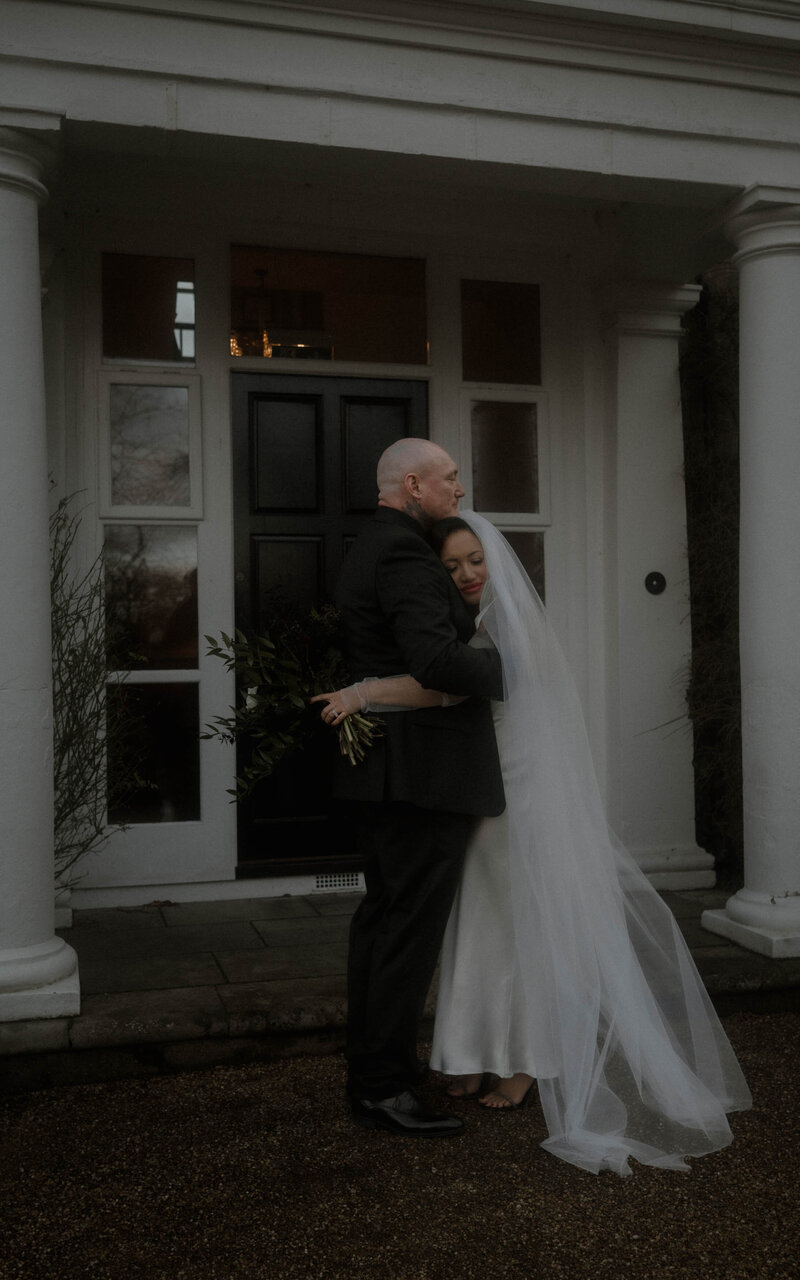 Intimate moment of a couple embracing outdoors, capturing their love and connection in a beautiful, serene setting celebrating their unique bond with timeless elegance
