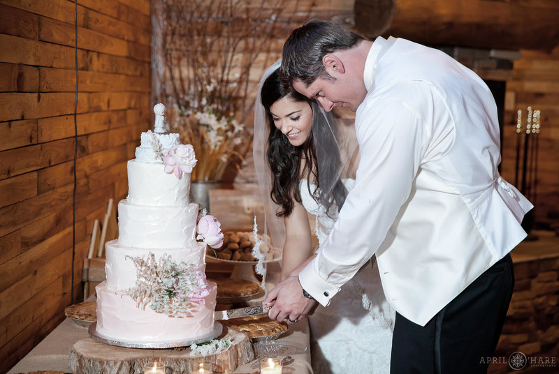 Cake cutting inside barn at Mountain View Ranch wedding reception