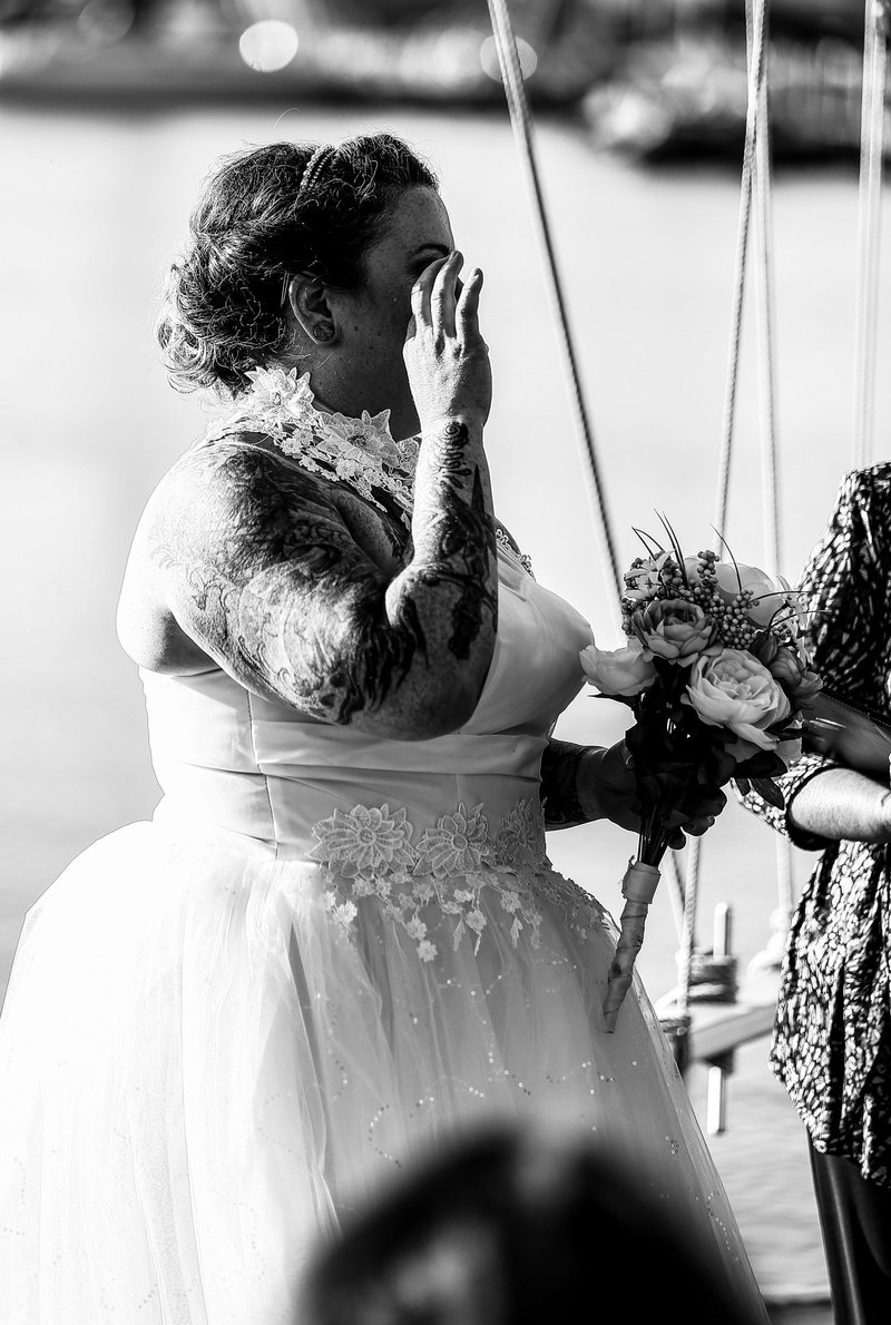 Bride wiping away a tear during an Erie Yacht Club wedding ceremony