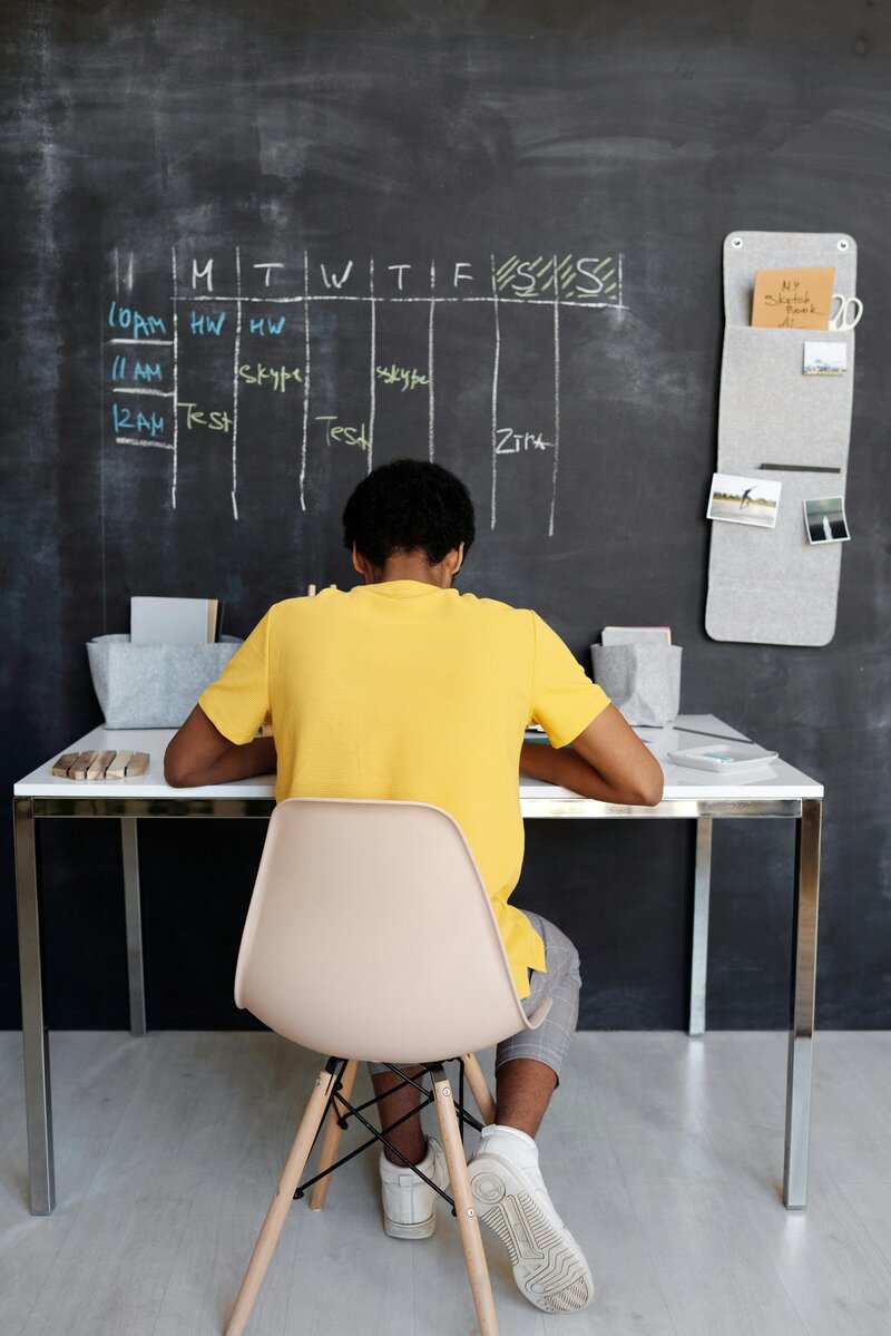 Organized student working by himself at his desk