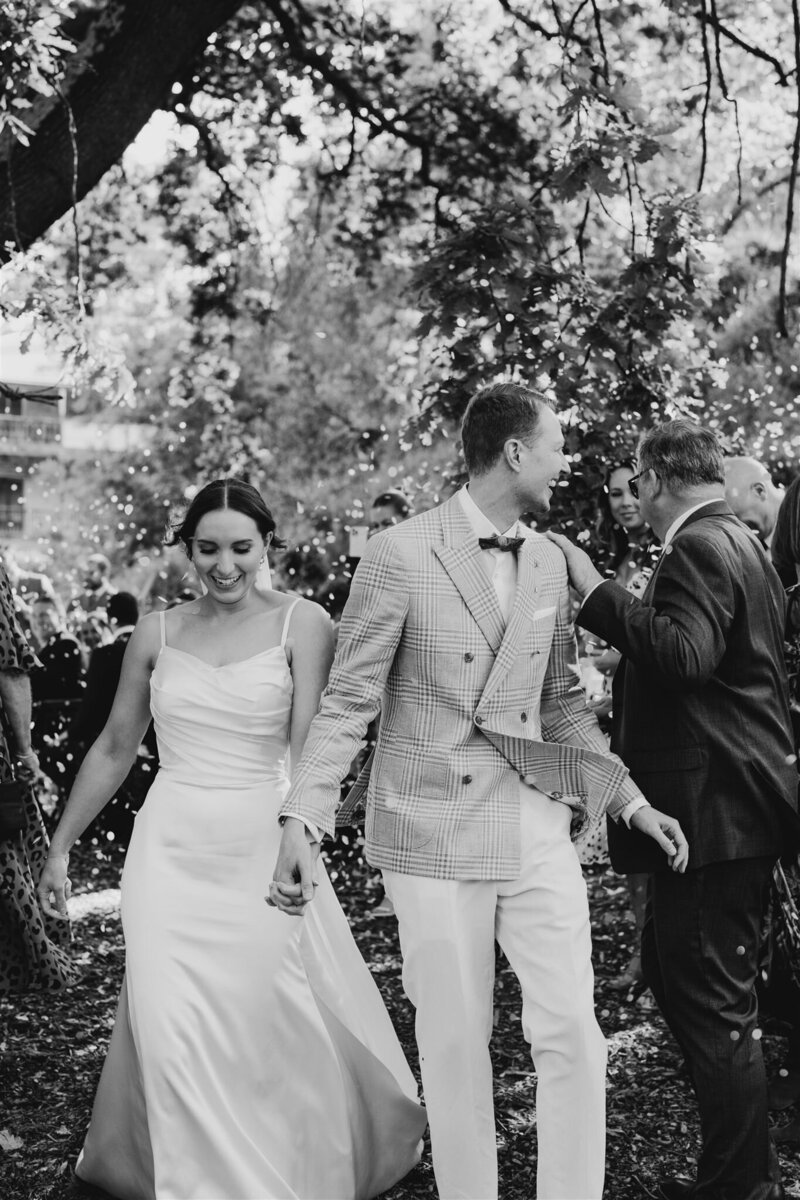 Candid Wedding Photography of Maddie and Hamish, captured in this stunning photo enjoying their bridal portraits at Collingwood Children's Farm.