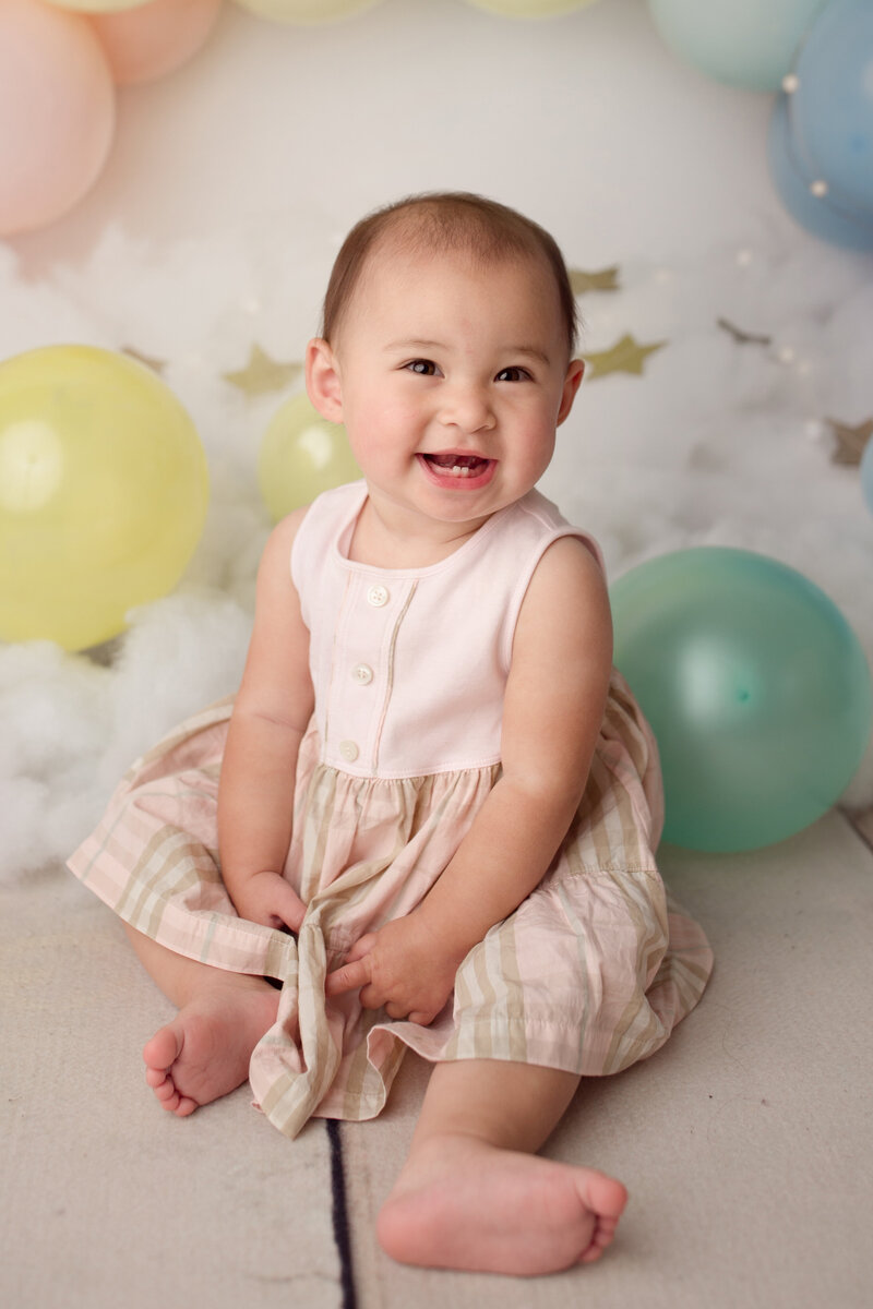 baby girl smiling during her birthday photo session done by new jersey children photographer