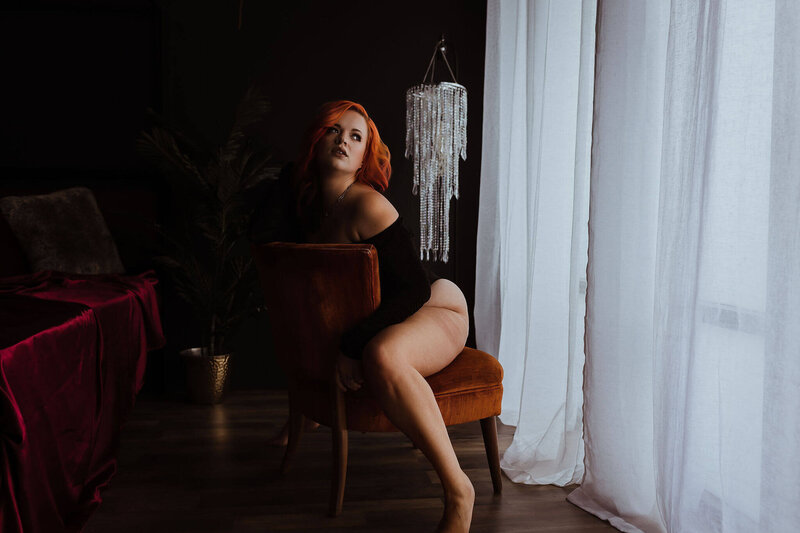 seattle washington boudoir photographer posing on chair looking away