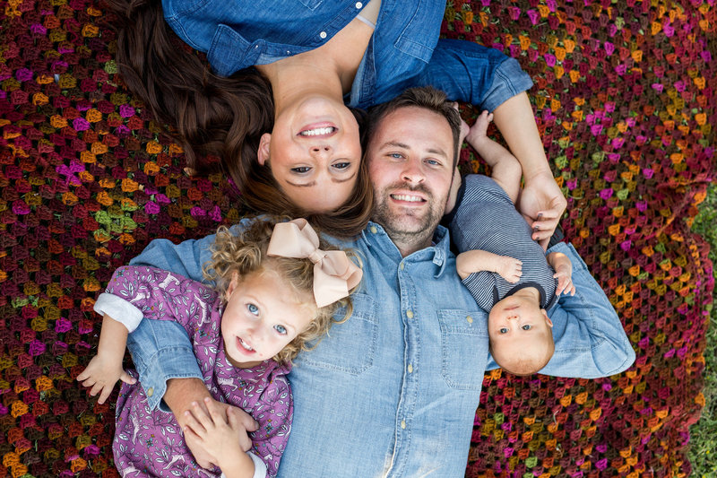 San Antonio family portrait photographer Expose The Heart Photography image of family session laying on ground of leaves