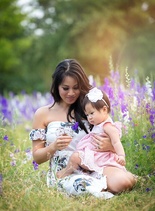 Mother and daughter in wildflower field.
