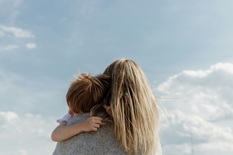 A mother holding her baby. Representing someone that is in therapy for mothers in Manhattan, New York.  Where a specially trained postpartum depression therapist can improve your fourth trimester.