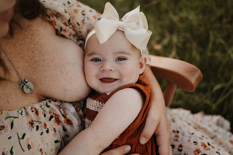mom breastfeeding baby and baby smiling