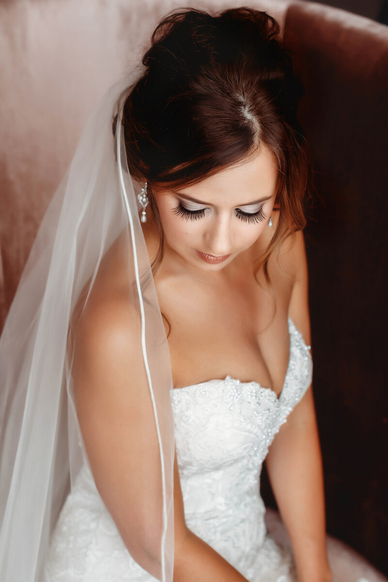 Bride peers out the window of a classic rolls royce on her Micro Wedding day in Asheville, NC.